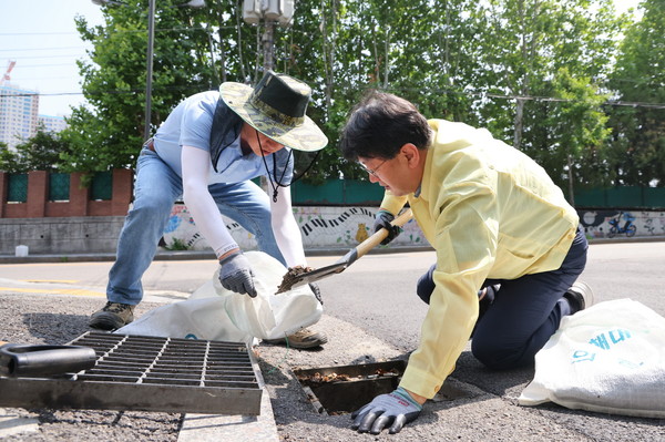 안치권 부시장이(가운데) 장마철 침수 대비 빗물받이 정비작업을 돕고있다/ 사진=의왕시 제공